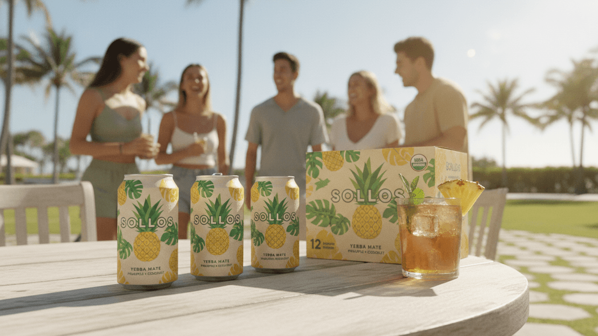 Three cans of Sollos Yerba Mate, a 12-pack box, and a glass of the drink on a wooden table outdoors.