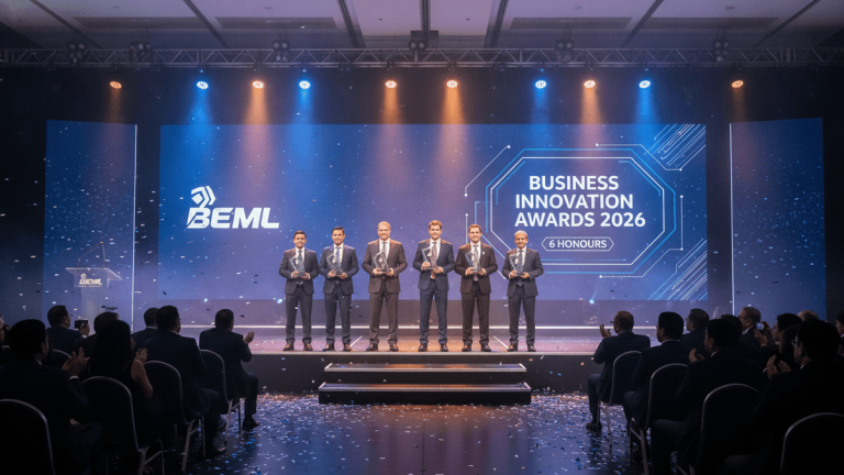Six men in suits stand on a brightly lit stage holding awards in front of a large screen displaying "BEML" and "Business Innovation Awards 2026."