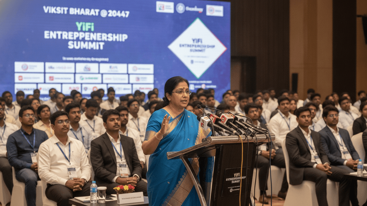 India's Finance Minister Nirmala Sitharaman, in a blue saree, speaks at a podium with microphones to a large seated audience. A large screen behind her displays the "YiFi Entrepreneurship Summit" logo.